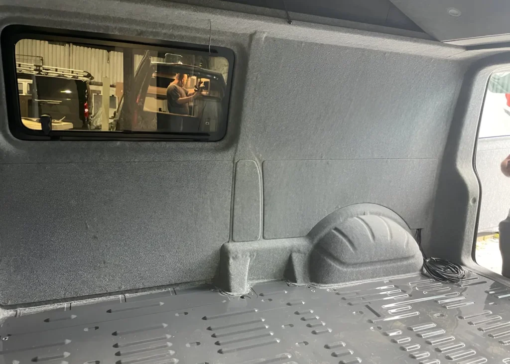 Camper van interior with insulated panels and side window installation