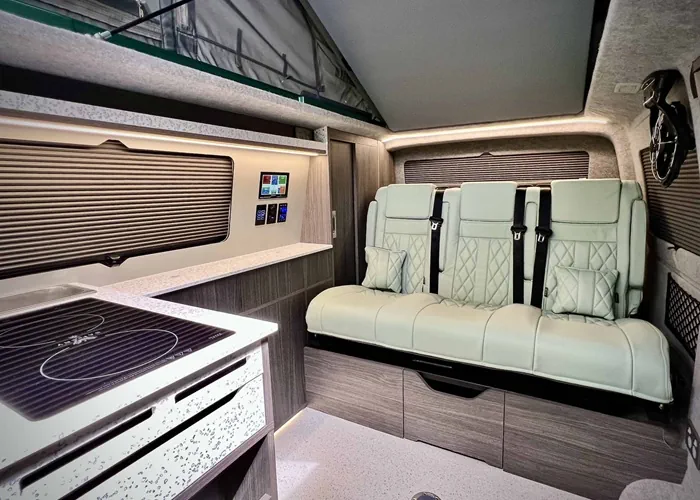 Camper van interior with leather seats and kitchenette