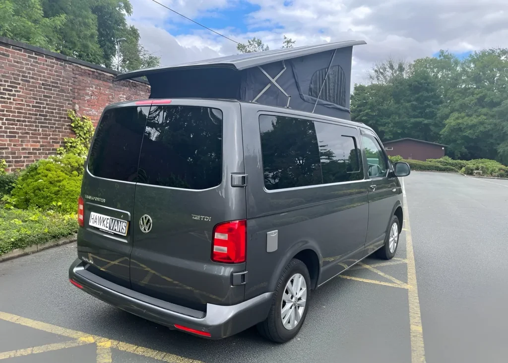 Rear view of camper van with pop-up roof outdoors