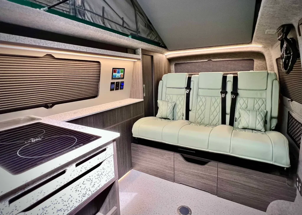 Modern VW camper interior with kitchen and seating