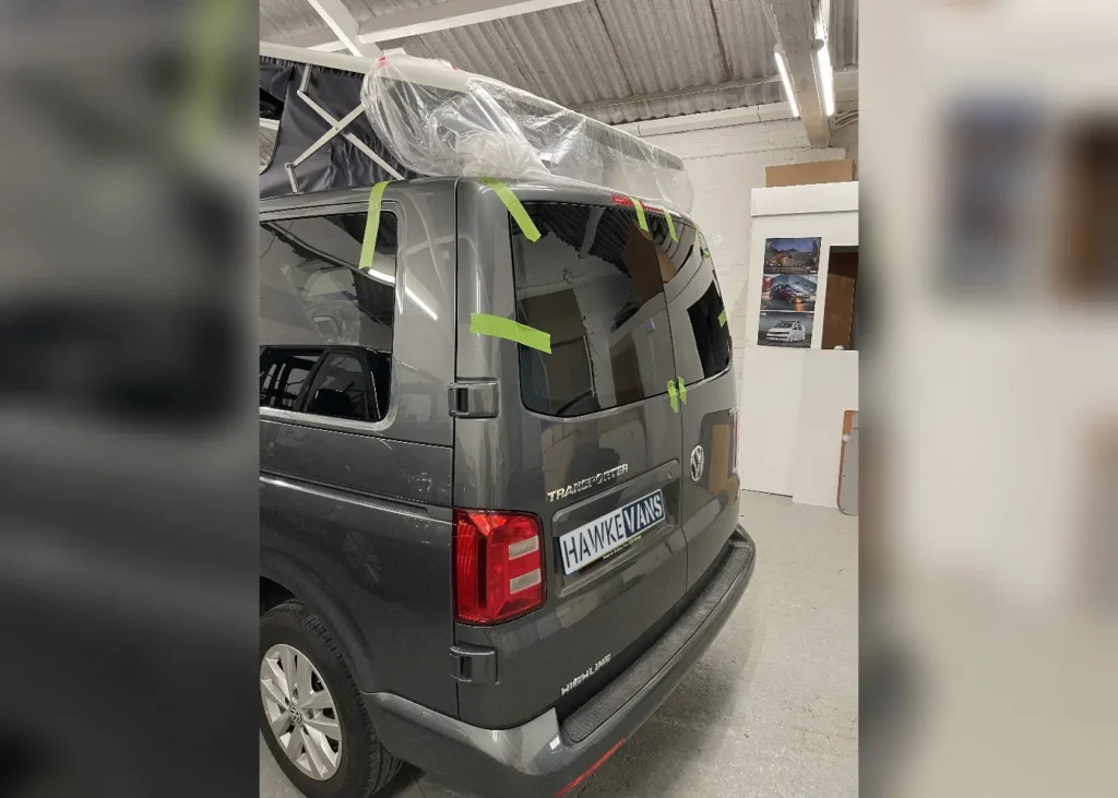 Camper van in workshop during window installation