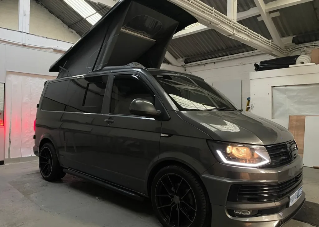 Dark camper van with a partially open pop-up roof