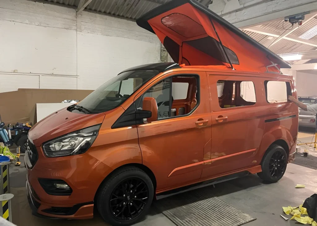 Orange camper van before windows