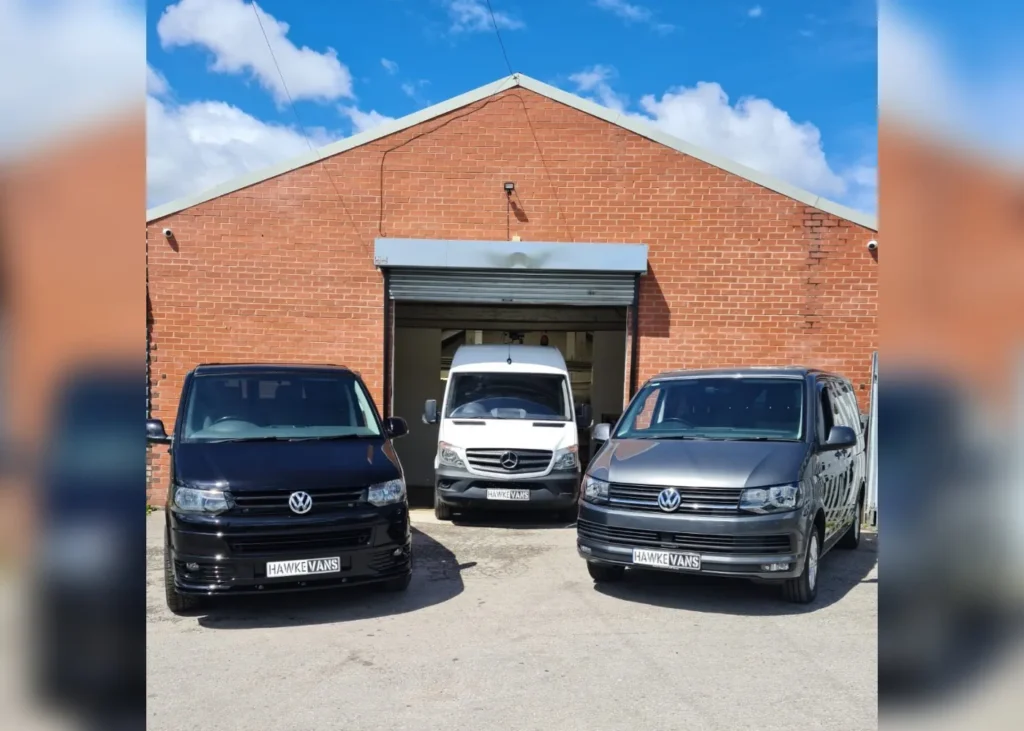 Hawke Vans workshop front with parked campers